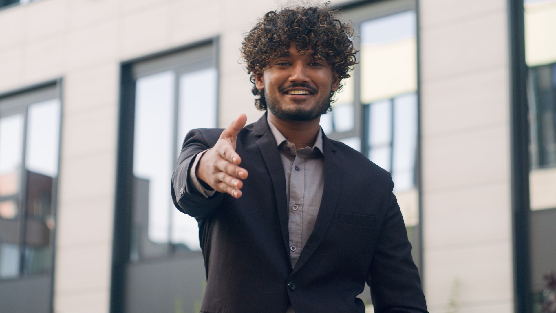 Close up Indian business worker man Arabian businessman male entrepreneur employer manager leader HR recruiter extend hand for handshake welcome gesture handshaking inviting formal greeting in city